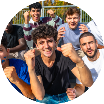 Group of teens forming a circle and smiling by facing downwards