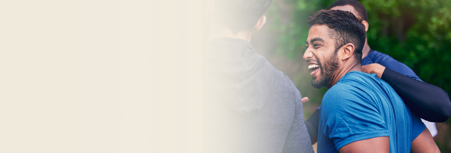 A man laughing with group of friends living his happy moments